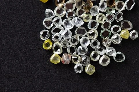 Natural rough diamonds in the sorting process close up Stock Photos