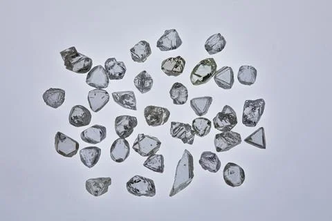 Natural rough diamonds in the sorting process close up Stock Photos
