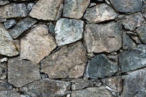 Natural rough stone wall background full frame close up texture concept for rock Stock Photos