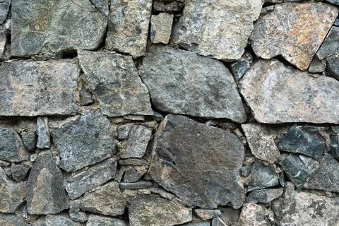Natural rough stone wall background full frame close up texture concept for rock Stock Photos
