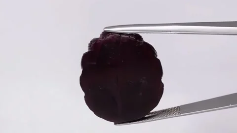 Natural ruby carving lion face in the tweezers Stock Footage 178642667