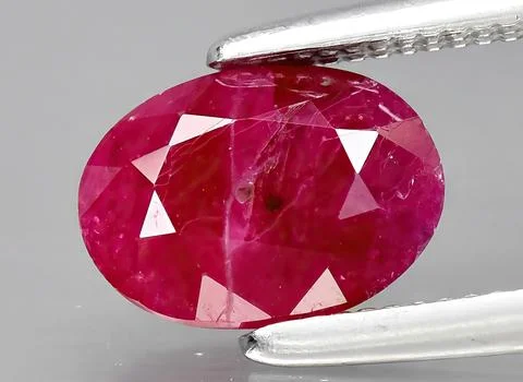 Natural ruby gem on the background Stock Photos