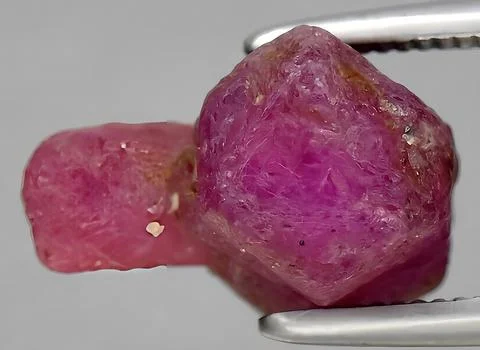 Natural ruby rough gem on the background Stock Photos