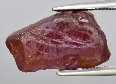 Natural ruby rough gem on the background Stock Photos