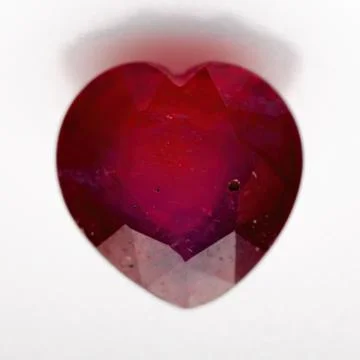 Natural ruby in the shape of a heart on a white background Stock Photos