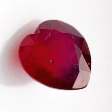 Natural ruby in the shape of a heart on a white background Stock Photos