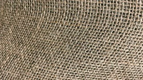 Natural rustic burlap or jute textile background texture with a rough, coar.. Stock Photos