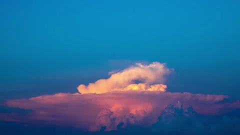 A natural scene where clouds dissipate at sunset and dusk Stock Footage 243987980