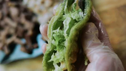 Natural serving composition: adding creamy pickle sauce to a lettuce wrap Stock Photos