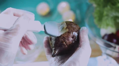 Natural serving moment: holding a dark cooked beet Stock Footage 342173223