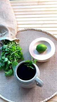 Natural setup with eco-friendly ceramic coffee cup, fresh mint spilling onto Stock Photos