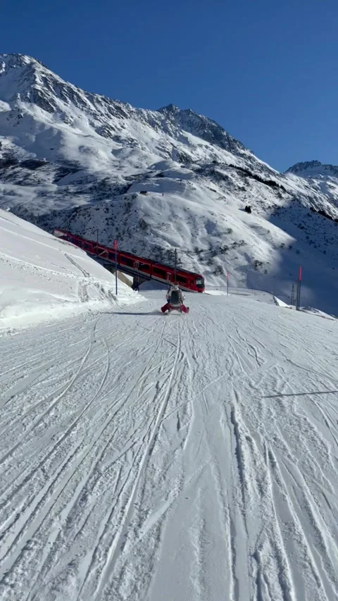 A natural sledding and ski slope with a train view in Andermatt, Switzerland Video stock 329888043