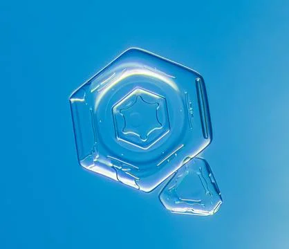 Natural snowflake crystal in blue background Stock Photos