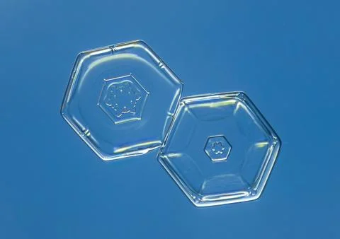 Natural snowflake crystal in blue background Stock Photos