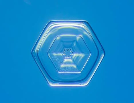 Natural snowflake crystal in blue background Stock Photos