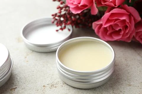 Natural solid perfume and flowers on light table, closeup Stock Photos