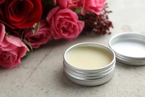 Natural solid perfume and flowers on light table, closeup Stock Photos