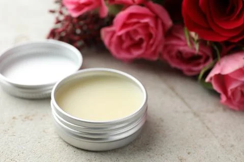 Natural solid perfume and flowers on light table, closeup Stock Photos