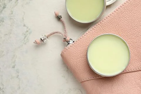 Natural solid perfume and leather bag on white textured background, flat la.. Stock Photos