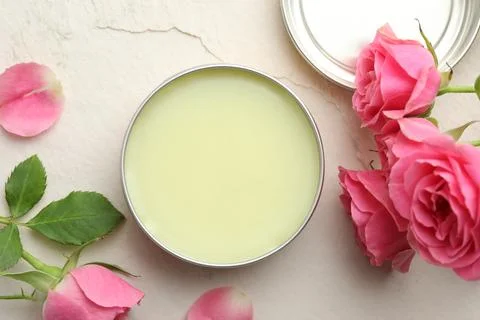 Natural solid perfume and pink roses on white textured background, flat lay Stock Photos