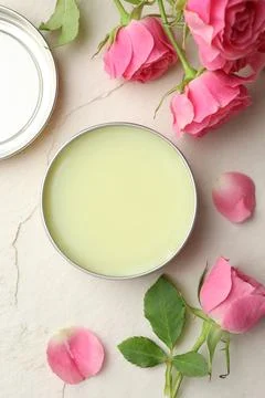 Natural solid perfume and pink roses on white textured background, flat lay Stock Photos
