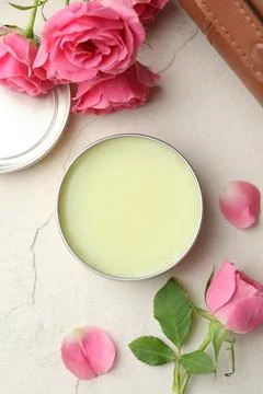 Natural solid perfume and pink roses on white textured background, flat lay Stock Photos