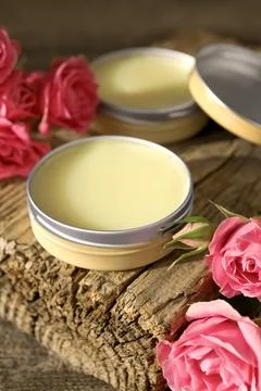 Natural solid perfume and pink roses on table, closeup Stock Photos