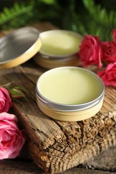 Natural solid perfume and pink roses on wooden table, closeup Stock Photos