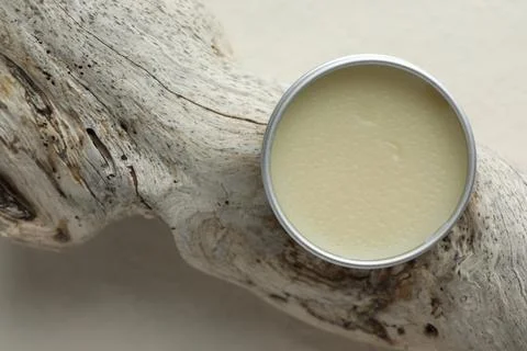 Natural solid perfume in container and snag on white background, top view Stock Photos