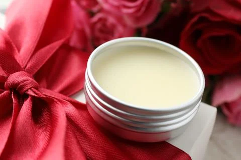 Natural solid perfume in container, gift box and flowers on table, closeup Stock Photos