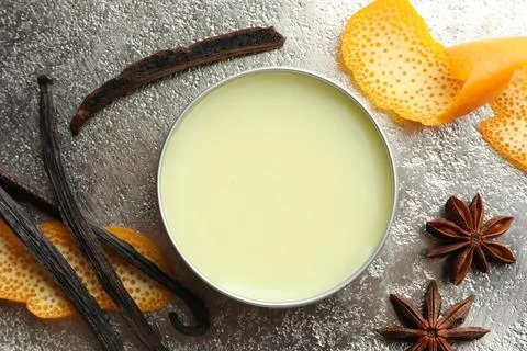 Natural solid perfume in container, vanilla pods, anise stars and orange pe.. Stock Photos