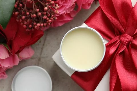 Natural solid perfume, gift box and flowers on light table, flat lay Stock Photos