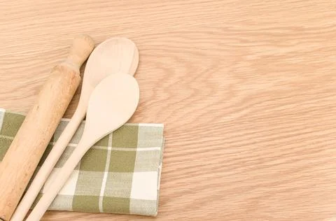 Natural solid wood kitchen tools and table napkin on a wooden tabletop Stock Photos
