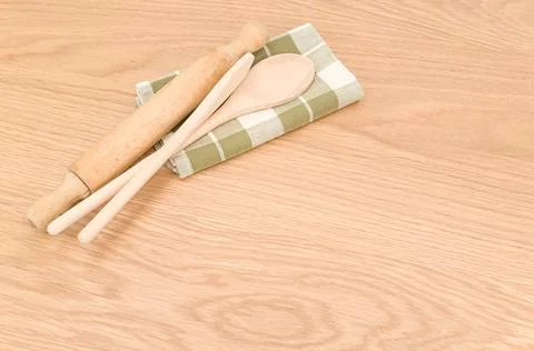 Natural solid wood kitchen tools and table napkin on a wooden tabletop Stock Photos