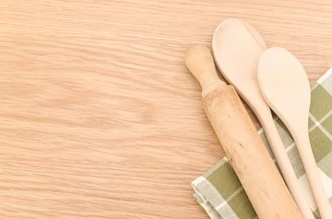 Natural solid wood kitchen tools and table napkin on a wooden tabletop Stock Photos