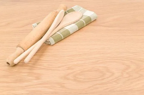 Natural solid wood kitchen tools and table napkin on a wooden tabletop Stock Photos