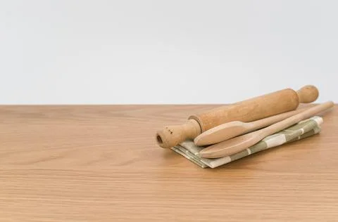 Natural solid wood kitchen tools and table napkin on a wooden tabletop Stock Photos