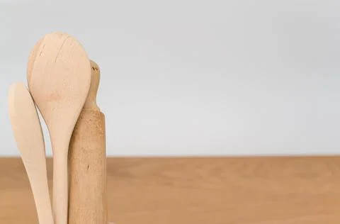 Natural solid wood kitchen tools and table napkin on a wooden tabletop Stock Photos