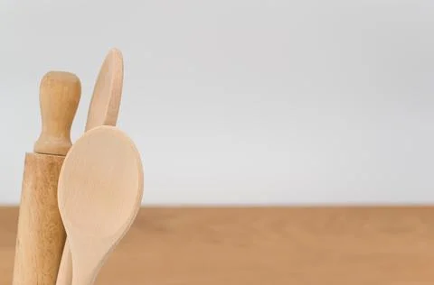 Natural solid wood kitchen tools and table napkin on a wooden tabletop Stock Photos