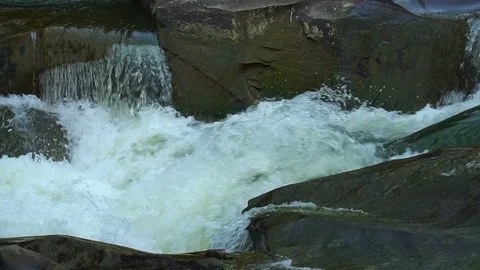 Natural spring drops fall in slow motion. Water flows dribbles and fall in drops Stock Footage 95646621