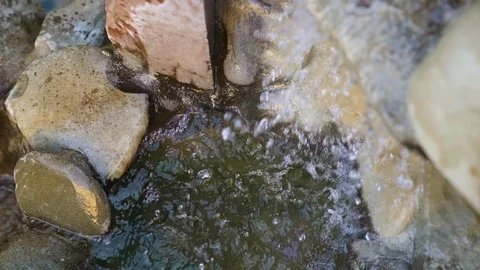 Natural spring drops fall in slow motion. Water flows dribbles and fall in drops Stock Footage 95719907
