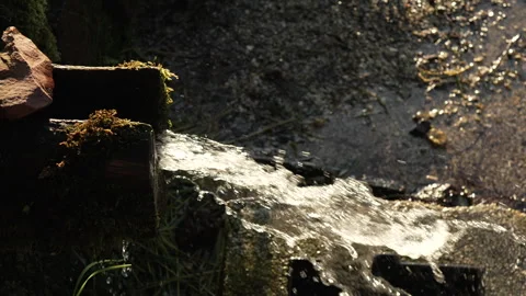 Natural spring with fresh water flow in the mountain in nature 스톡 동영상 247025922
