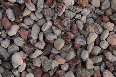 Natural Stone Background Texture with Multicolored River Pebbles and Gravel.. Stock Photos