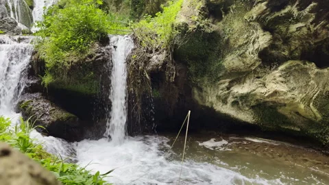 Natural stone cascade falling into the source in wild forest, bubbles, waves and Stock Footage 318220274
