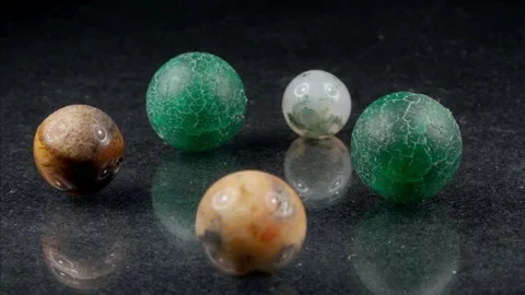 Natural stone on a dark background. Balls of various minerals. Beads. 動画素材 139487130