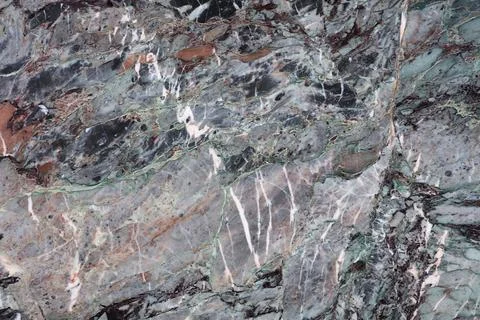 Natural stone surface showing patterns and colors found in a quarry or geol.. Stock Photos