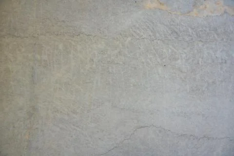 Natural stone surface with subtle cracks and weathered patterns. Stock Photos