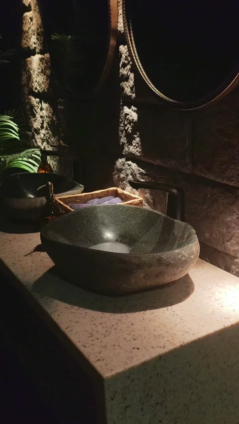 Natural Stone Vessel Sink In Rustic Bathroom With Dramatic Lighting Stock Footage 334575228