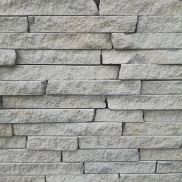 Natural stone wall background texture with horizontal stacked grey slate tiles Stock Photos