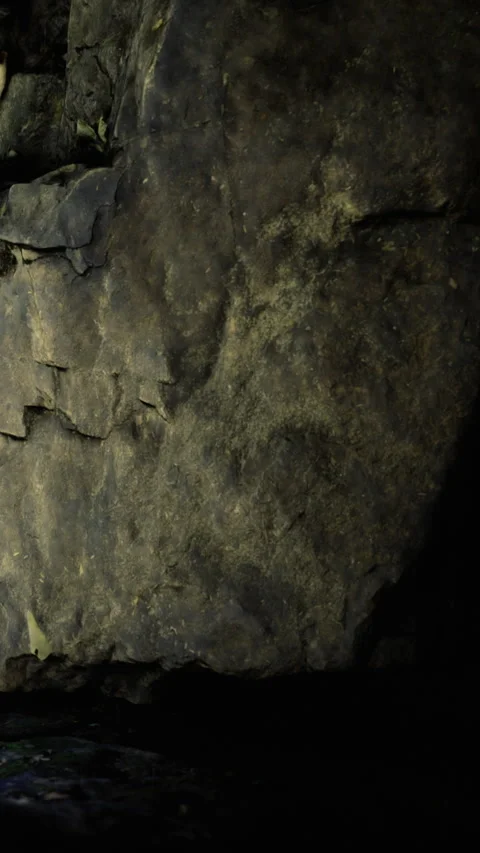 Natural stone wall with rough texture in a dark cave environment Stock Footage 334191854